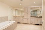 Basement level suite features jetted tub and dual sinks 